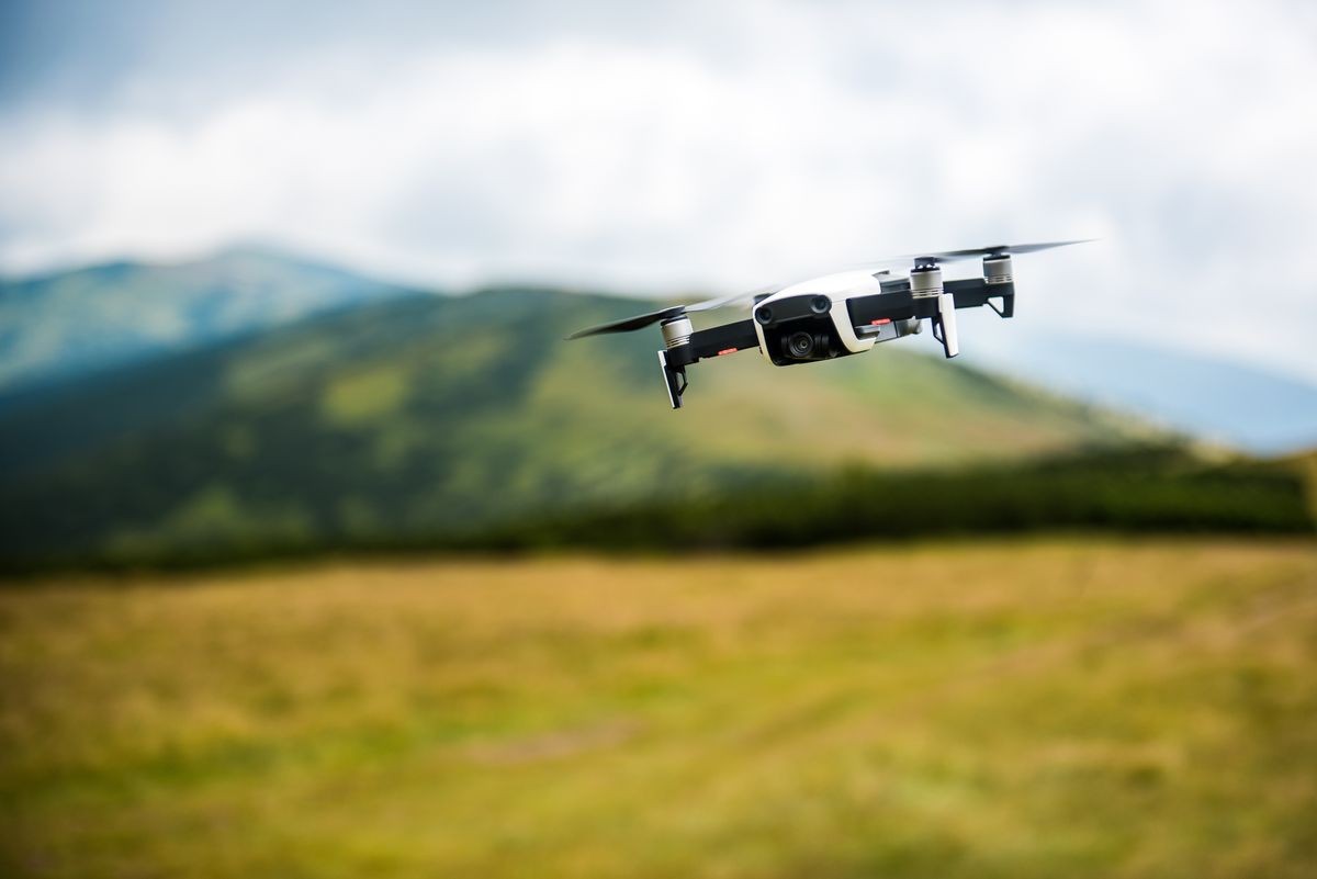 The drone with the professional camera takes pictures in the mountains